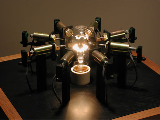 Kinetic sculpture: Tower.  Materials: Light bulb and socket, aluminum, solenoids, wood, control electronics (San Francisco Bay Area electronic sculpture)